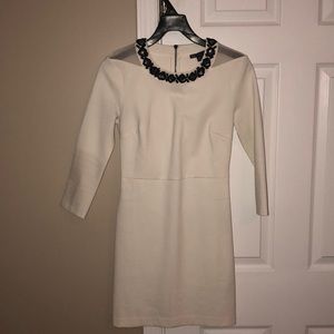 Armani Exchange white dress with neckline detail.
